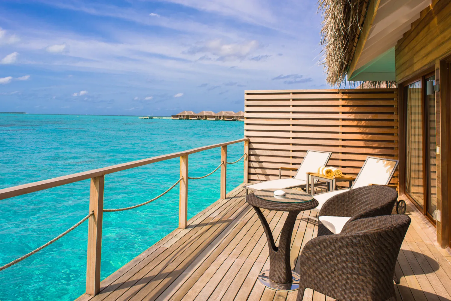 Brown Wicker Chairs and Table Beside Body of Water-调