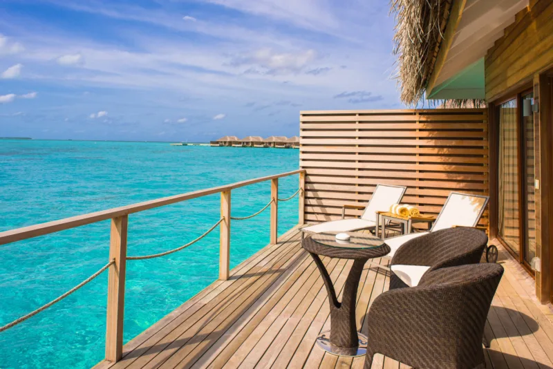Brown Wicker Chairs and Table Beside Body of Water-调